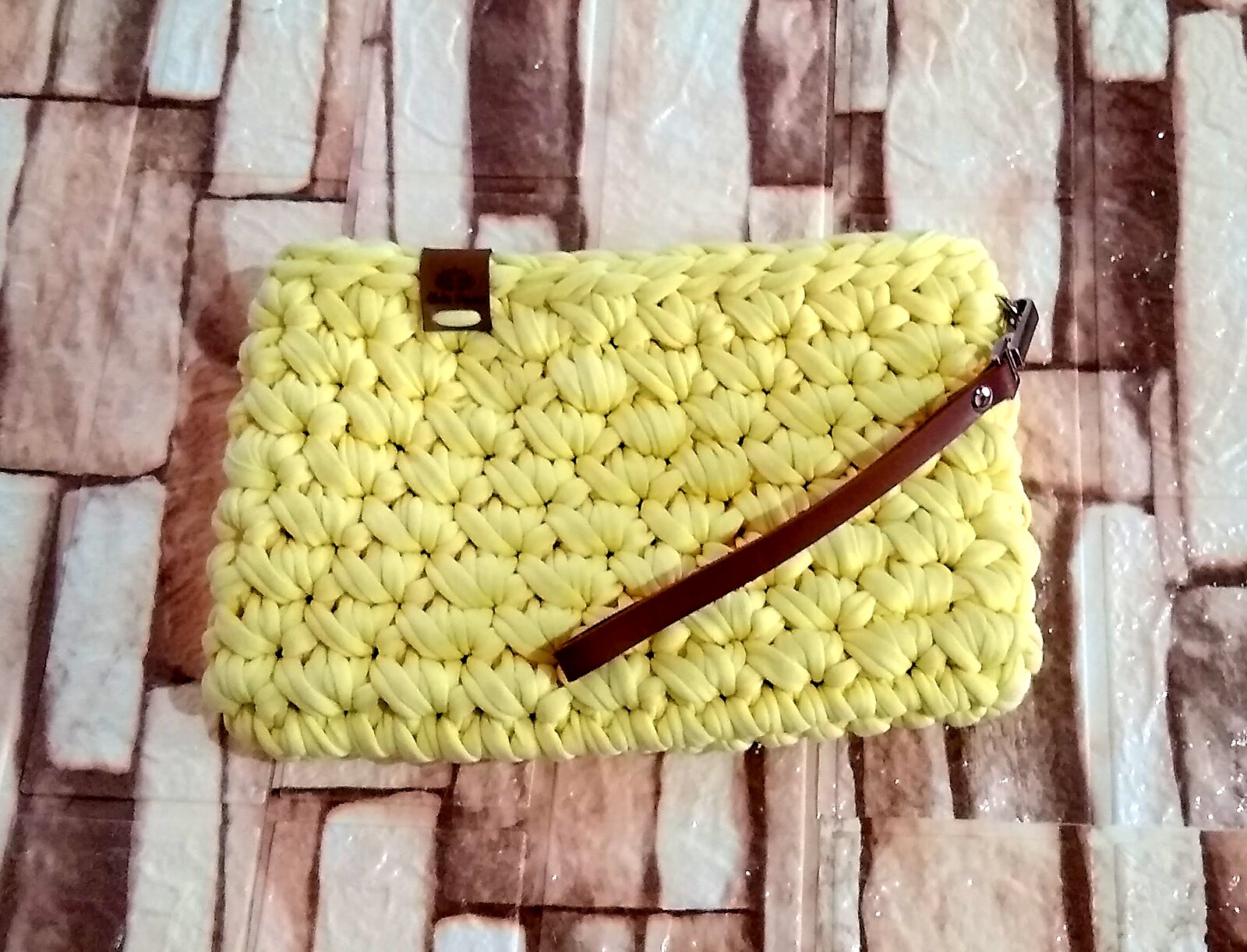 Clutch amarela em fio de malha com alça de couro marrom
